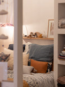 Simplicité fonctionnelle : Étagère en bois massif, astucieusement positionnée au-dessus du lit, ajoutant un espace de rangement sans compromettre le style minimaliste