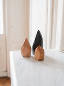 Menhir en bois brut posé sur une table contemporaine